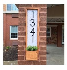 a brick building with a large number sign on it