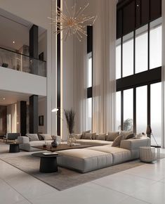 a large living room with high ceilings and floor to ceiling windows