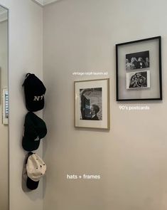 hats and frames are hanging on the wall