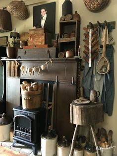 an old fashioned fireplace with pots and pans on it