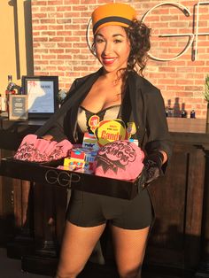 a woman in tights holding a tray of candy