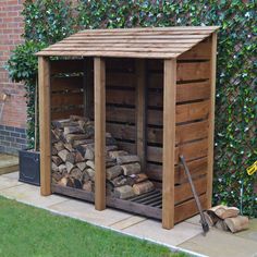 a wooden shed with logs stacked in it