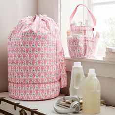 a pink bag sitting on top of a counter next to bottles