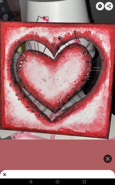 a red and white painting with a heart on it