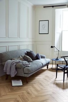 a living room filled with furniture next to a table and chair in front of a window