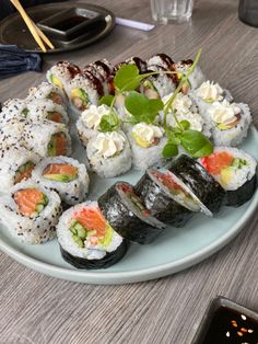 sushi is served on a plate with garnishes