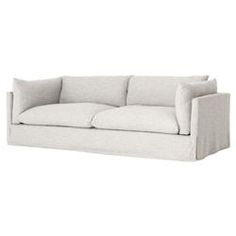 a white couch with two pillows on it