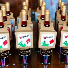 several bottles of wine sitting on top of a wooden table with brown paper bags around them