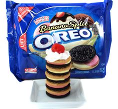 a stack of cookies and ice cream on a white plate with a bag of banana split oreo in the background