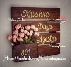 three wooden signs with names and flowers in them