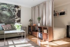 a living room filled with furniture and a painting on the wall