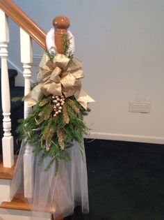 a christmas wreath on top of a banister