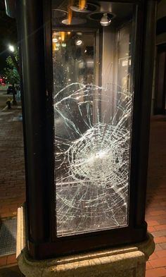 a broken glass window sitting on the side of a street