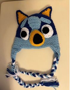 Do you have little ones who loves watching the cartoon Bluey? This beanie is crocheted with soft acrylic yarn from Hobby Lobby and is machine washable (gentle cycle) and dryer safe. However, it is best to hand wash crochet pieces and lay flat to dry. Colors in the hat are dark blue, light blue, black, gold and white. This beanie is a size S for a head circumference of 18".  Other sizes are available as special order. Please allow two weeks for those. Crochet Bluey, Bonnet Au Crochet, Crochet Pieces, Bonnet Crochet, The Cartoon, Crochet Hat, Head Circumference, Hobby Lobby, Acrylic Yarn