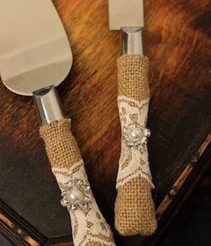 there are two knives with burlap handles on the table next to each other