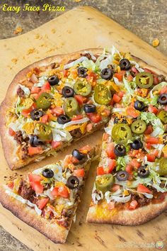 a pizza sitting on top of a wooden cutting board next to a slice missing from it