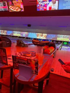 a bowling alley filled with bowling balls and tables