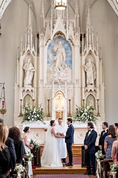 the bride and groom are getting married at the alter