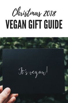 a person holding up a vegan gift card with the text, christmas 2018 vegan gift guide it's vegan