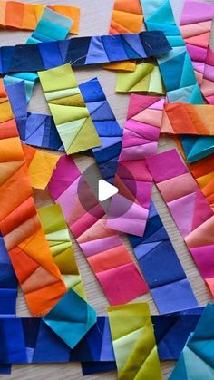 colorful pieces of paper laid out on a table