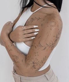 a woman with tattoos on her arms and chest