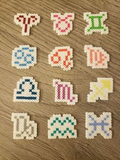 six different types of pixelated stickers on a wooden surface with the letters and numbers