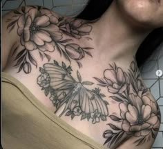 a woman's chest with flowers and butterflies on it