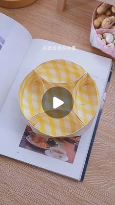 an open book with a yellow and white checkered plate sitting on top of it