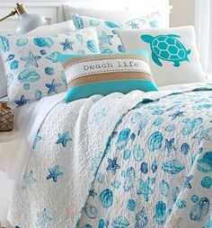 a bed covered in blue and white sea shells