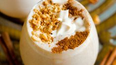 there is a milkshake with whipped cream and cinnamon sprinkles on top