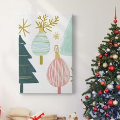 a christmas tree with presents under it in front of a wall hanging on the wall