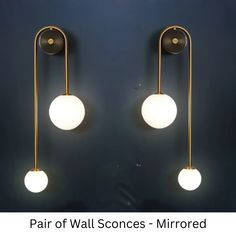 pair of wall sconces - mirrored with two white globes on each side