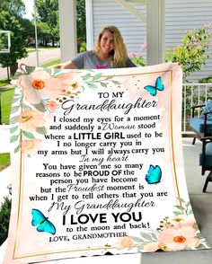 a woman holding up a blanket with the words to her granddaughter and butterflies on it