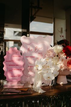 the table is set up with pink and white flowers