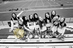 black and white photograph of cheerleaders on bleachers