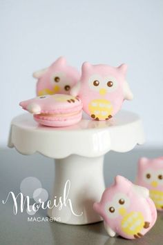 small pink and yellow owl cupcakes sitting on a cake stand with other little ones