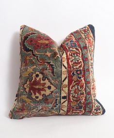 an antique rug pillow on a white background