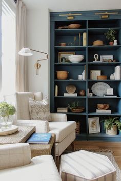 a living room filled with furniture and bookshelves