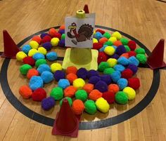 a basketball court with colorful pom poms on it and a turkey card in the center