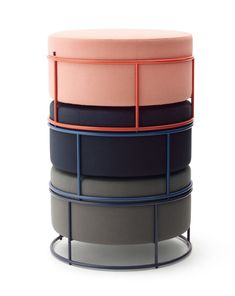 four round stools stacked on top of each other with different colors and shapes in them