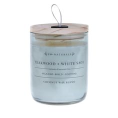 a white candle with a wooden lid on a white background and the words teakwood & white sage in front of it