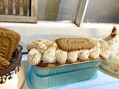 two tins filled with cookies sitting on top of a table next to each other