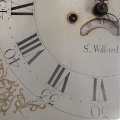 an old clock face with roman numerals and numbers on the dial, showing time