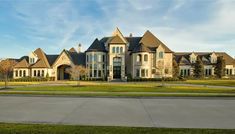 a large house with many windows and lots of grass