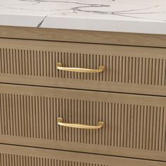 a close up of a dresser with two drawers and a marble counter top in the background