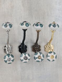 four different types of knobs and handles on a white surface with blue flowered designs