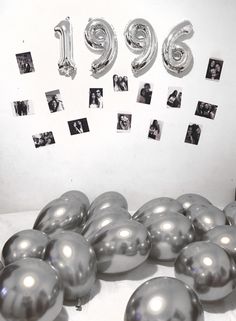 balloons and photos are arranged in the shape of numbers