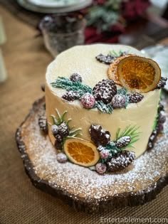 a decorated cake sitting on top of a wooden slice