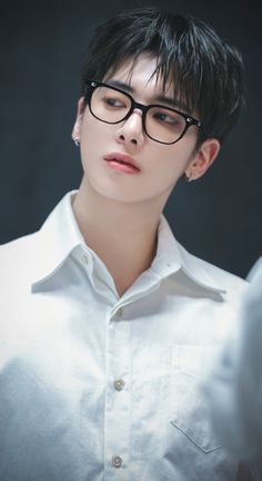 a person wearing glasses and a white shirt