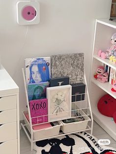 a white shelf filled with books and toys